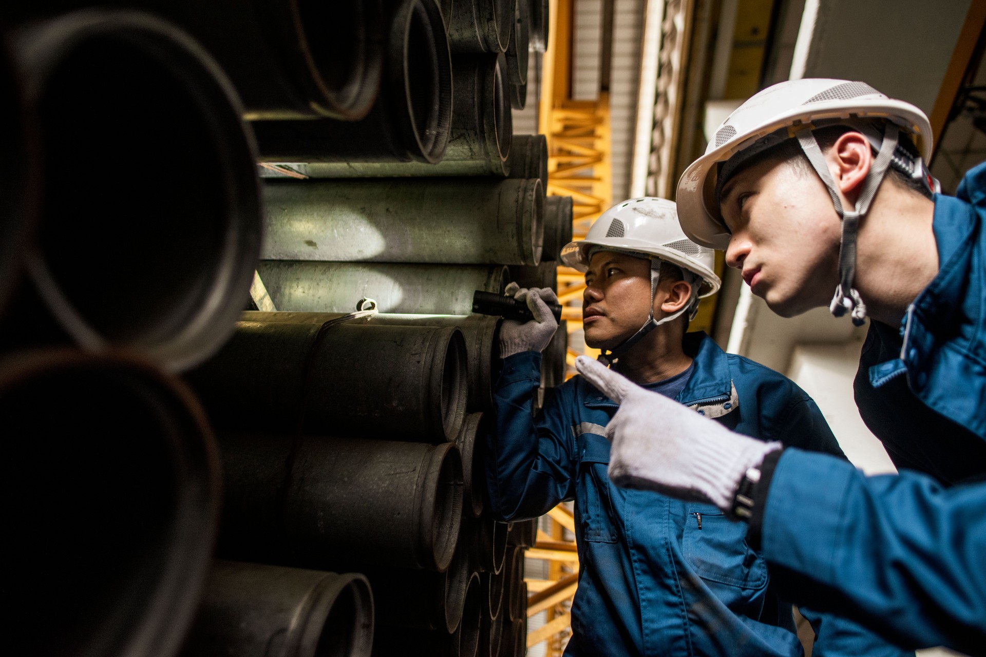 Asian workers at work in steel factory